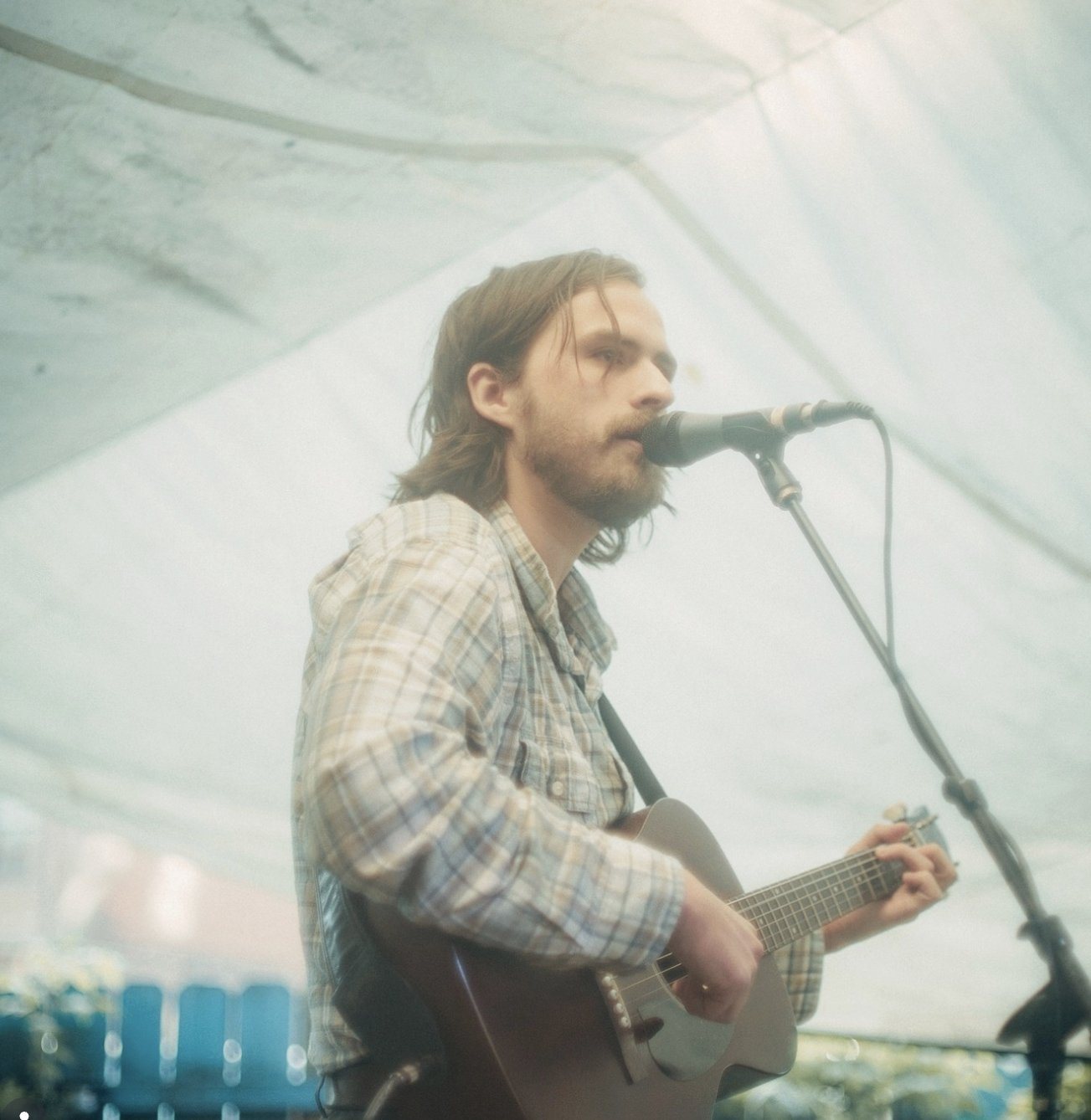 Roland Dixon performing live under a tent