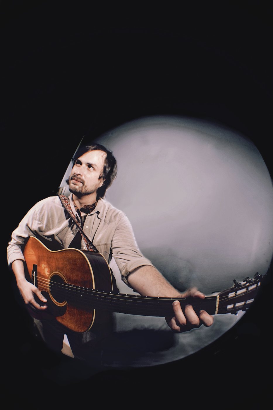 Roland Dixon with acoustic guitar, fisheye